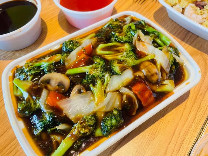 Broccoli with mushrooms in rich brown sauce, glossy and colorful