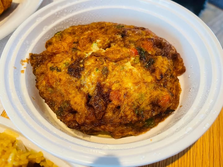 Egg foo young patty close-up, golden brown and textured