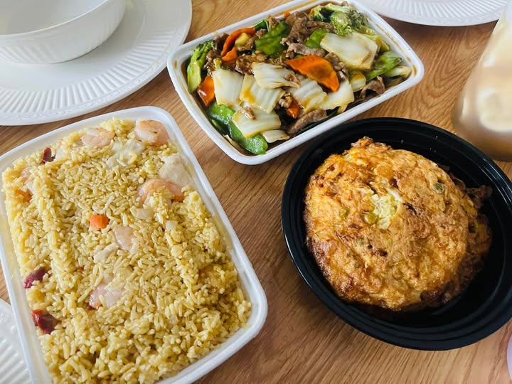 Three-dish spread: shrimp fried rice, vegetable stir-fry with beef, and egg foo young patty
