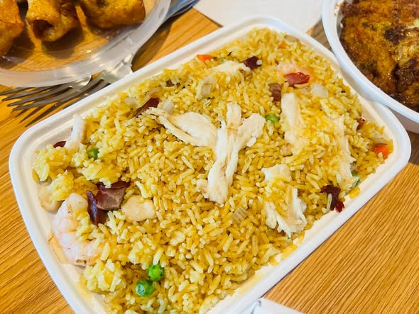 Shrimp fried rice close-up with visible shrimp, chicken, peas, and pork bits